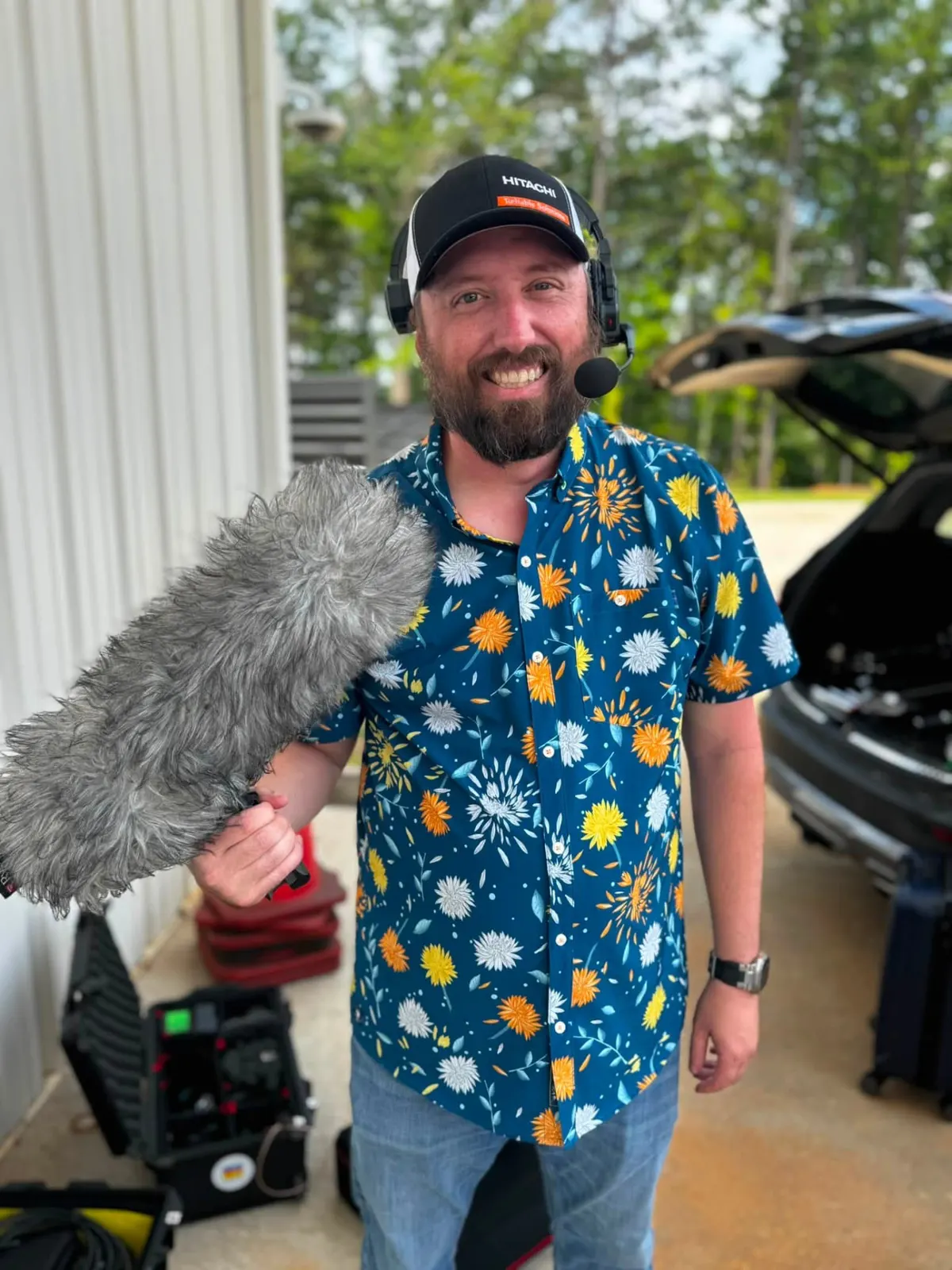 Sound operator holding a boom mic with a big smile