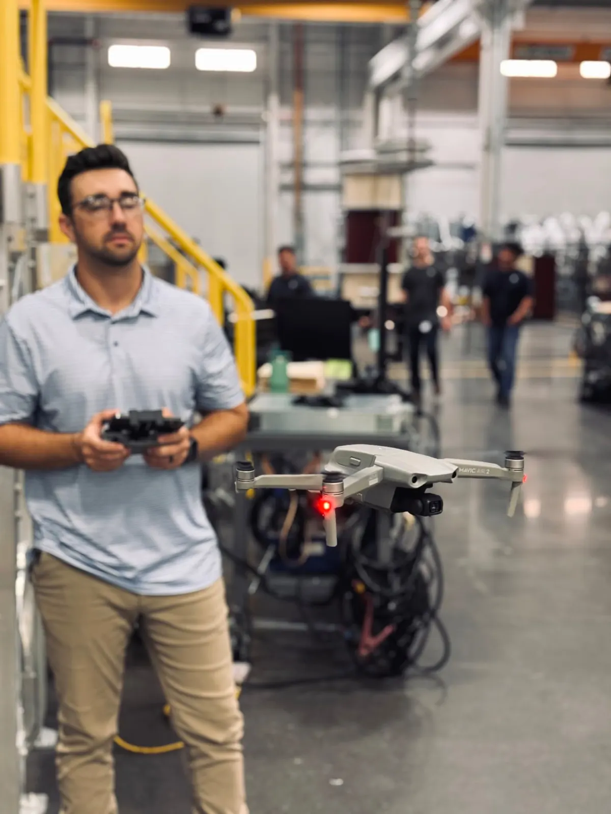 Drone pilot preparing a shot inside a factory
